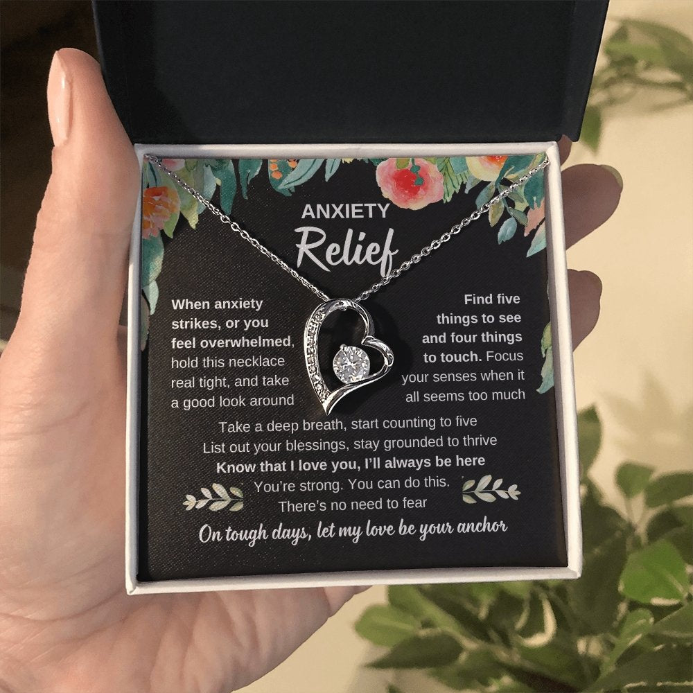 anxiety silver heart pendant in hand
