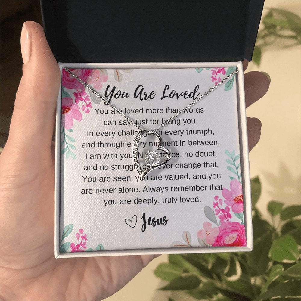 christian you are loved  heart necklace  in hand